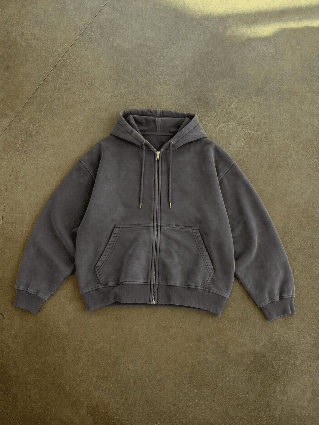 Dark gray hoodie on a textured brown background