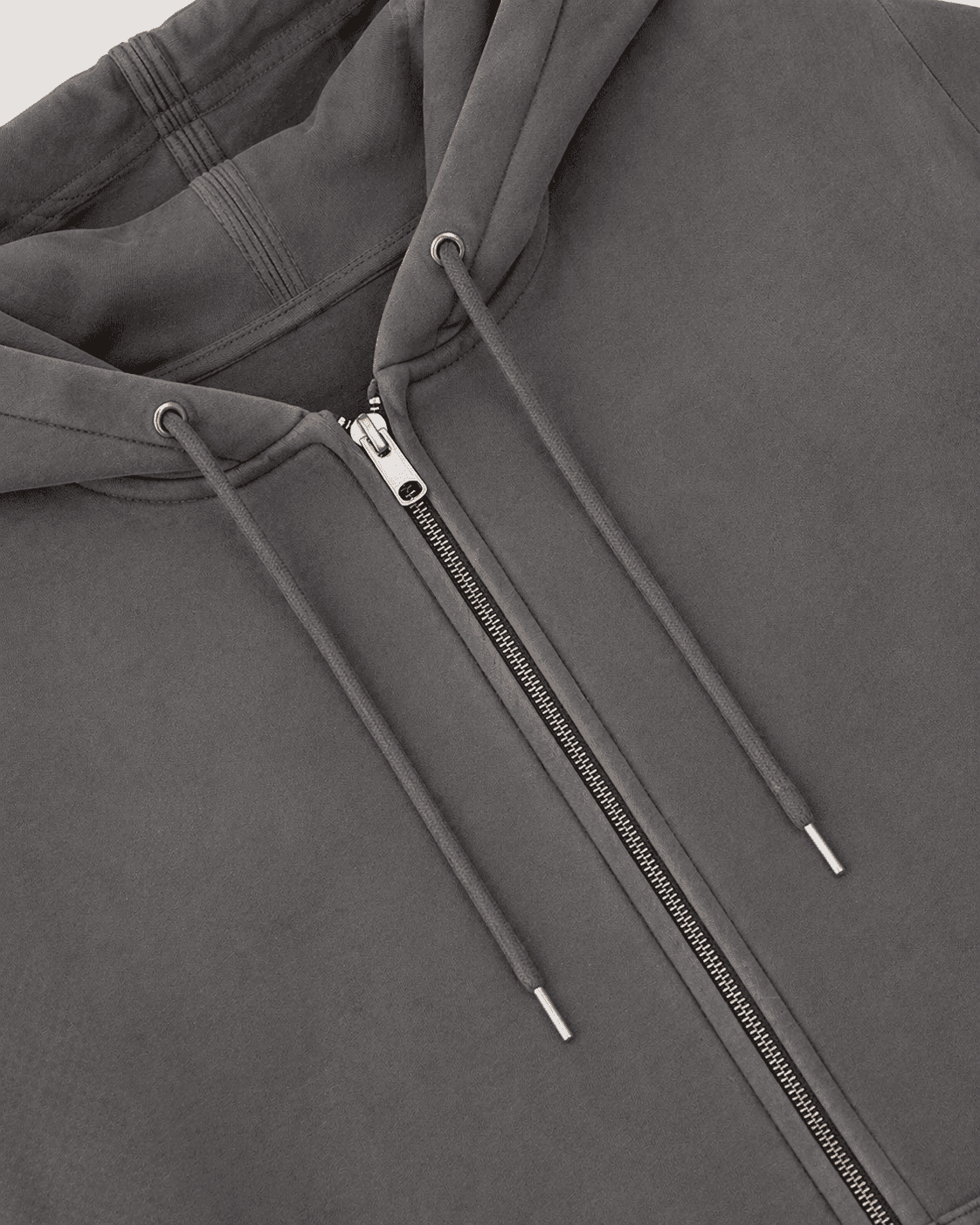 Close-up of a gray hoodie with a zipper and drawstrings.