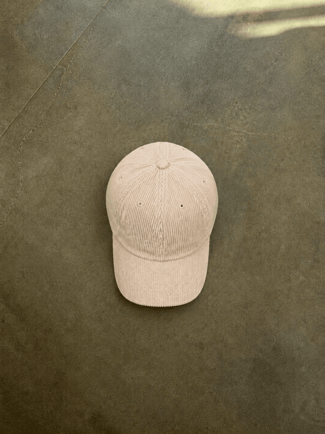 Brown cable knit sweater with a brand logo on a concrete floor