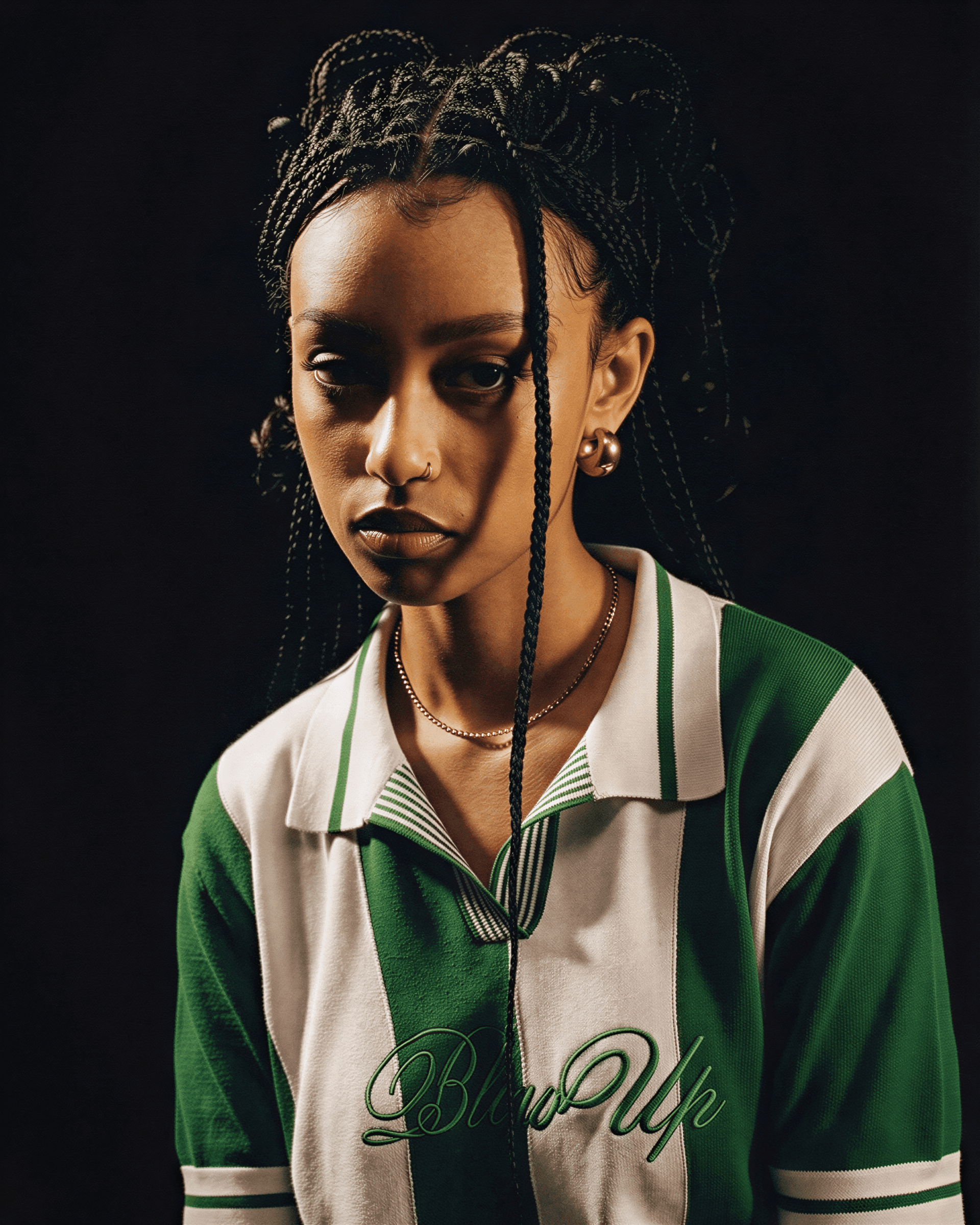 Person wearing a green and white sports jacket with 'Brown Skin' text on a black background