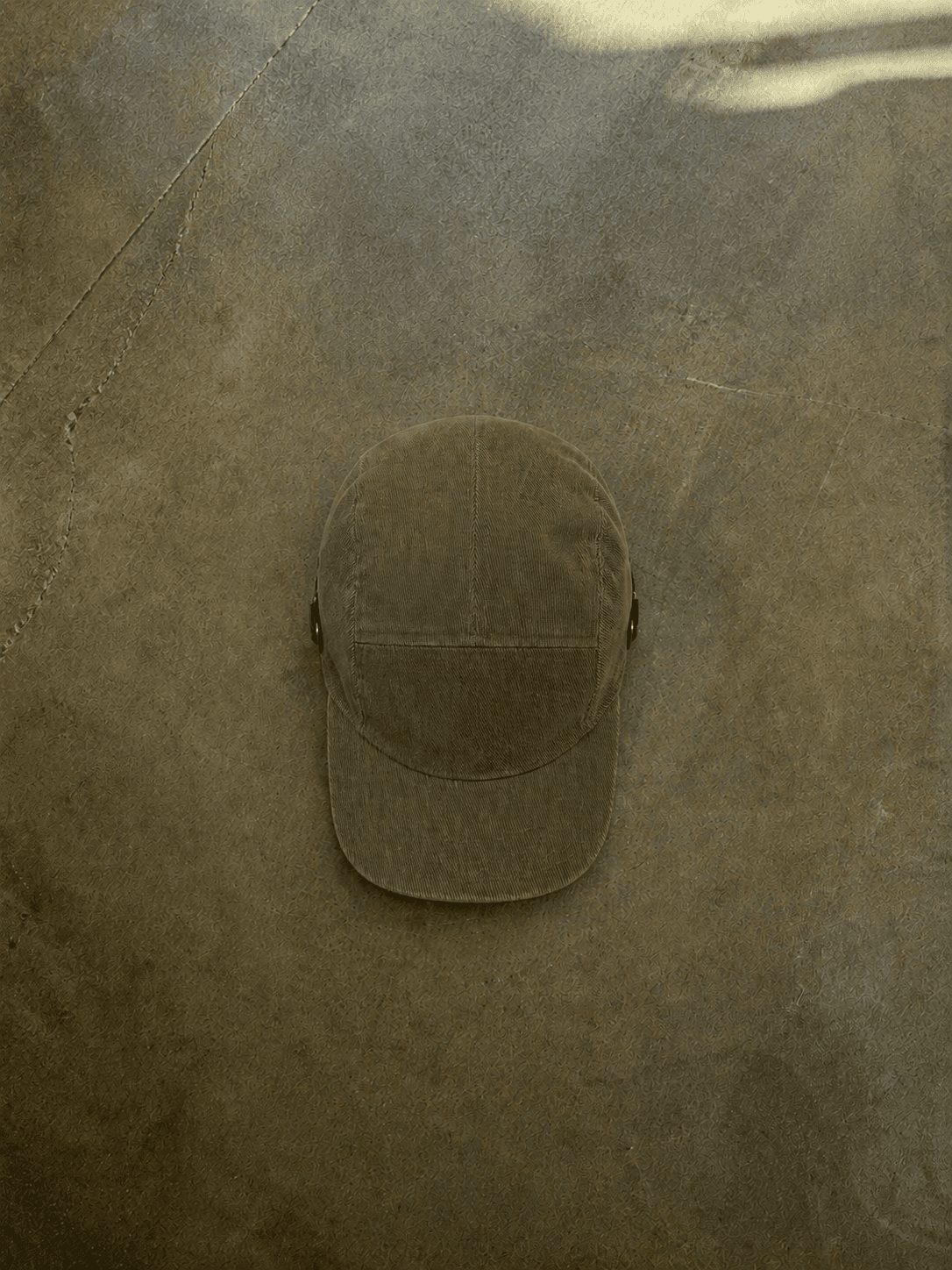Brown cable knit sweater with a brand logo on a concrete floor